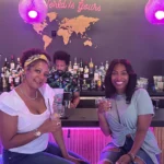 Two women holding drinks at a Birmingham Restaurant