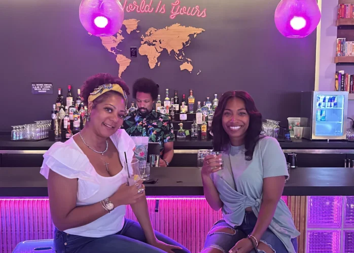 Two women holding drinks at a Birmingham Restaurant