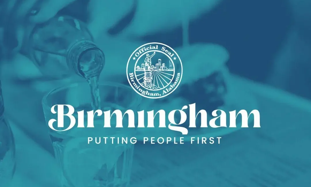 A person pouring a clear liquid into a glass of ice, with a blue color overlay featuring the official seal of Birmingham, Alabama, and the text "Birmingham: Putting People First."