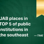 A graphic with a textured dark green background and a gold ribbon hanging in the top right corner. Large white text reads, "UAB places in TOP 5 of public institutions in the southeast," with a smaller attribution to TIME in the bottom right.