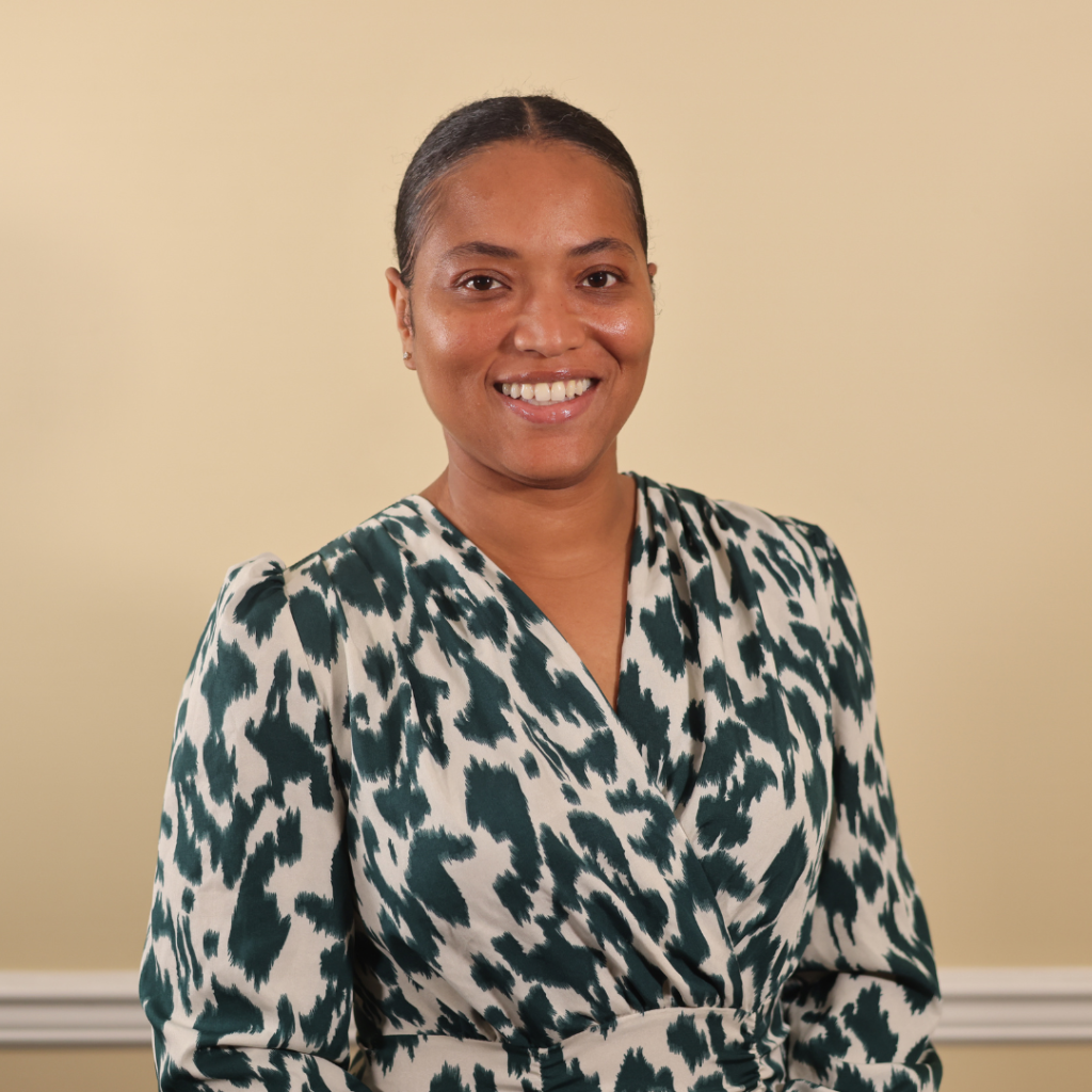 Professional headshot of LaKeela Lowe in a green and white patterned blouse.