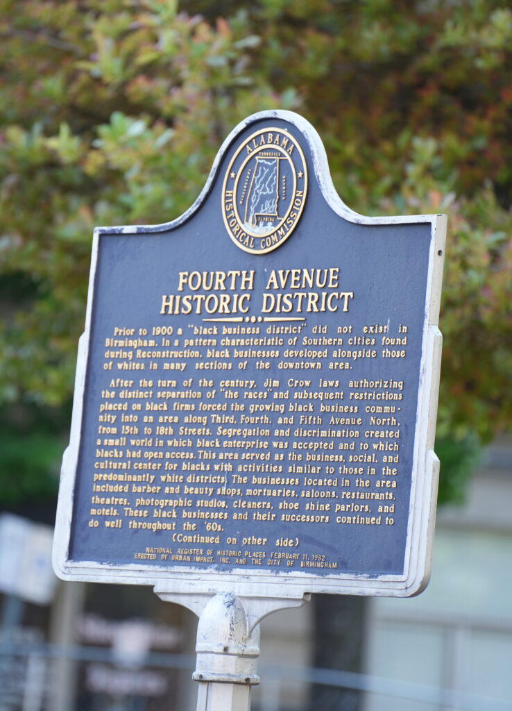 An Alabama Historical Commission marker for the "Fourth Avenue Historic District," detailing its history as a thriving Black business and cultural center that developed in Birmingham during segregation.